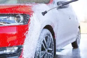 car being washed with a foam cannon